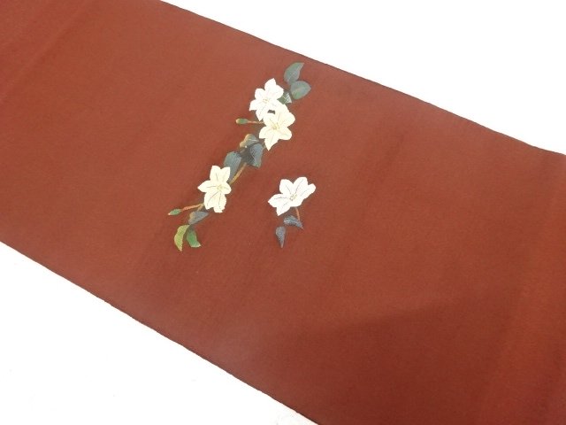 Bag belt with woven branch and flower pattern